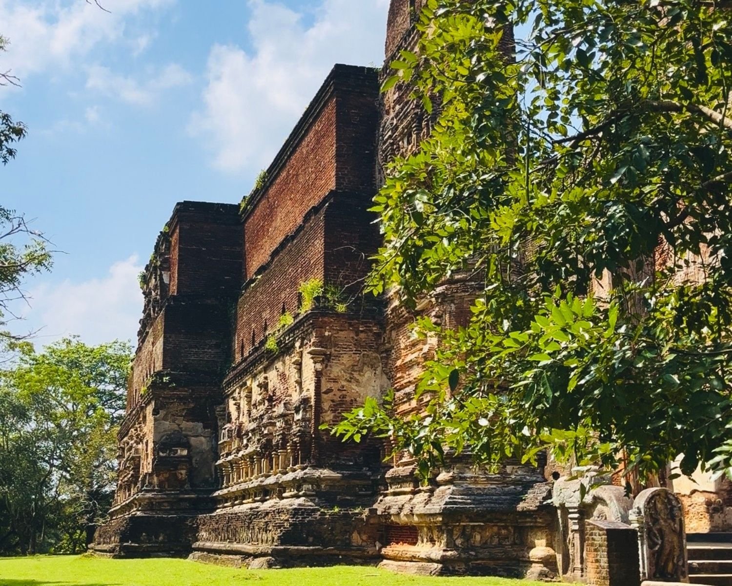 South wall of Lankatilaka with miniature shrine reliefs, molded base, and east entrance balustrades