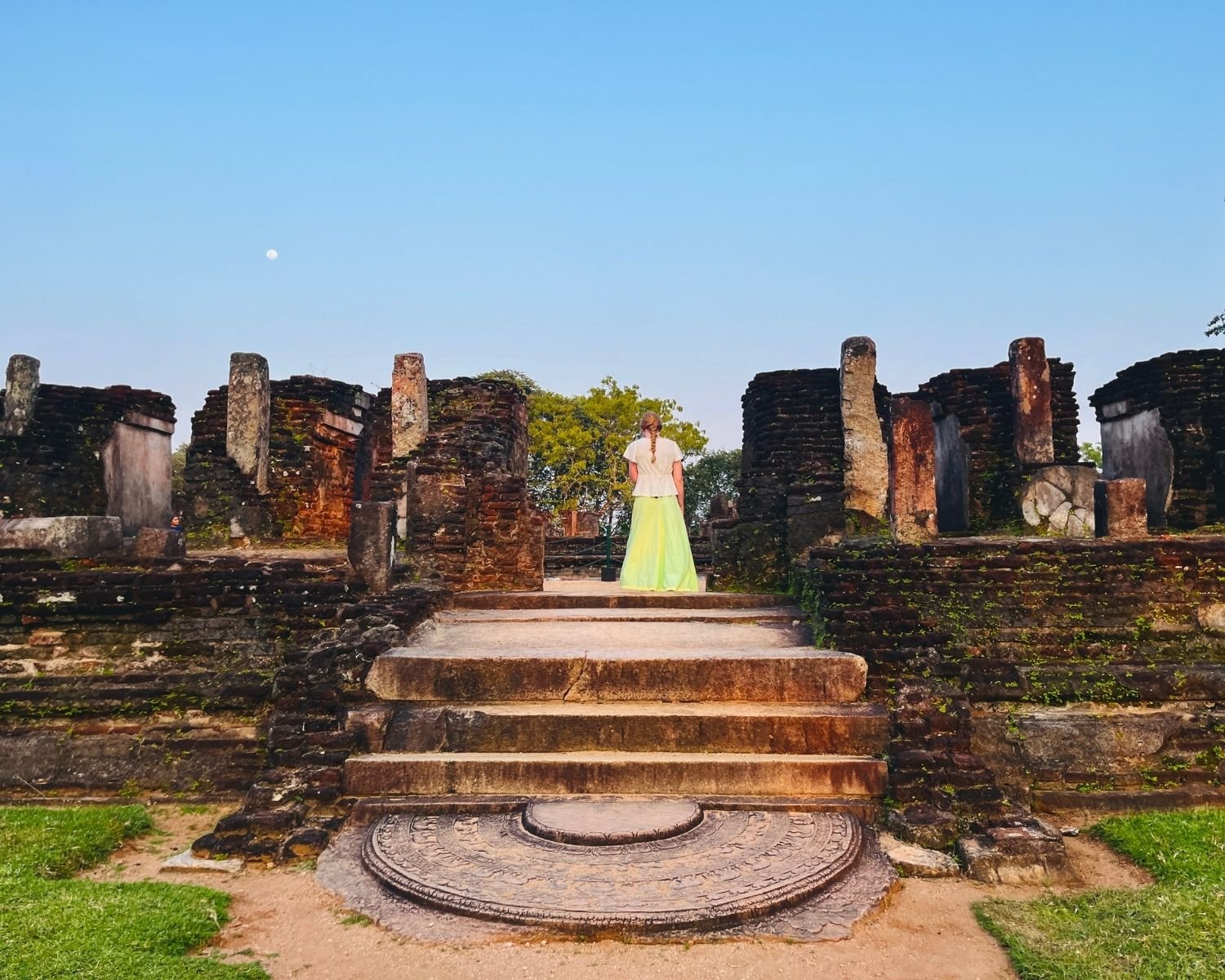 Moonstone at base of Baddhasima Prasadaya steps with brick ruins and pillars under moonrise