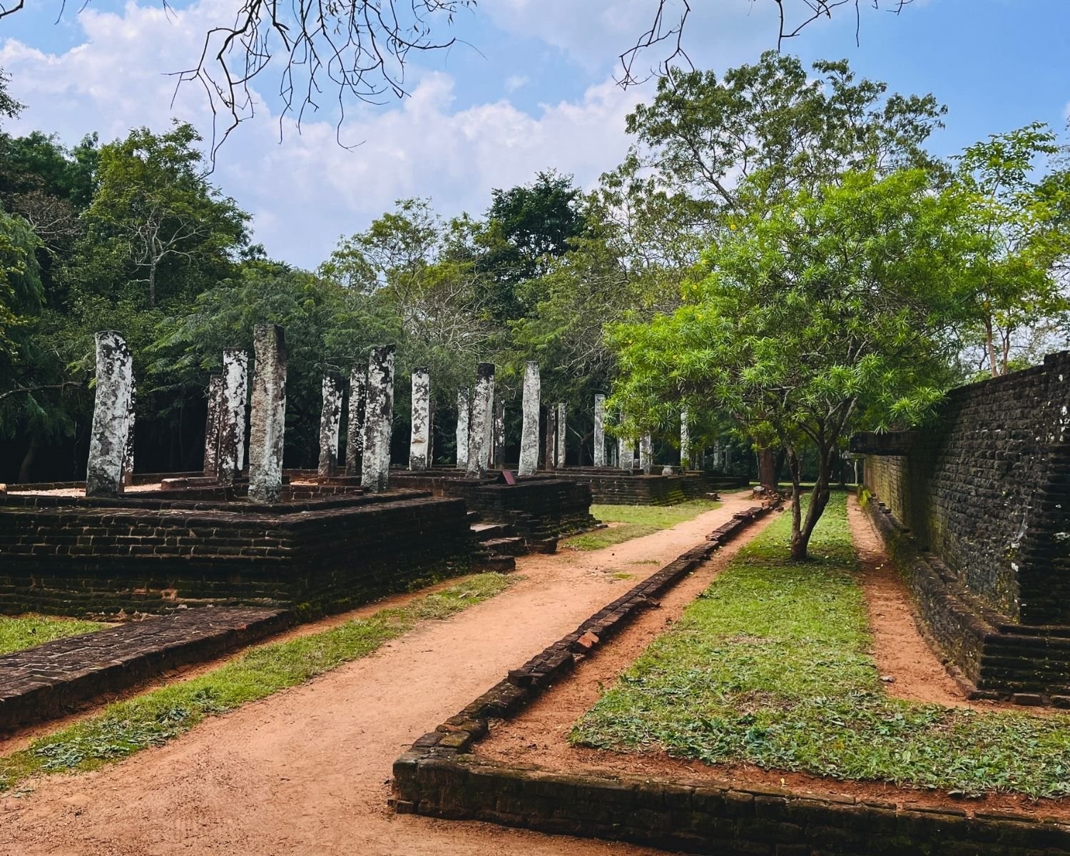 Pathway through lower terrace at Potgul Vihara with residential cell remains and central terrace wall