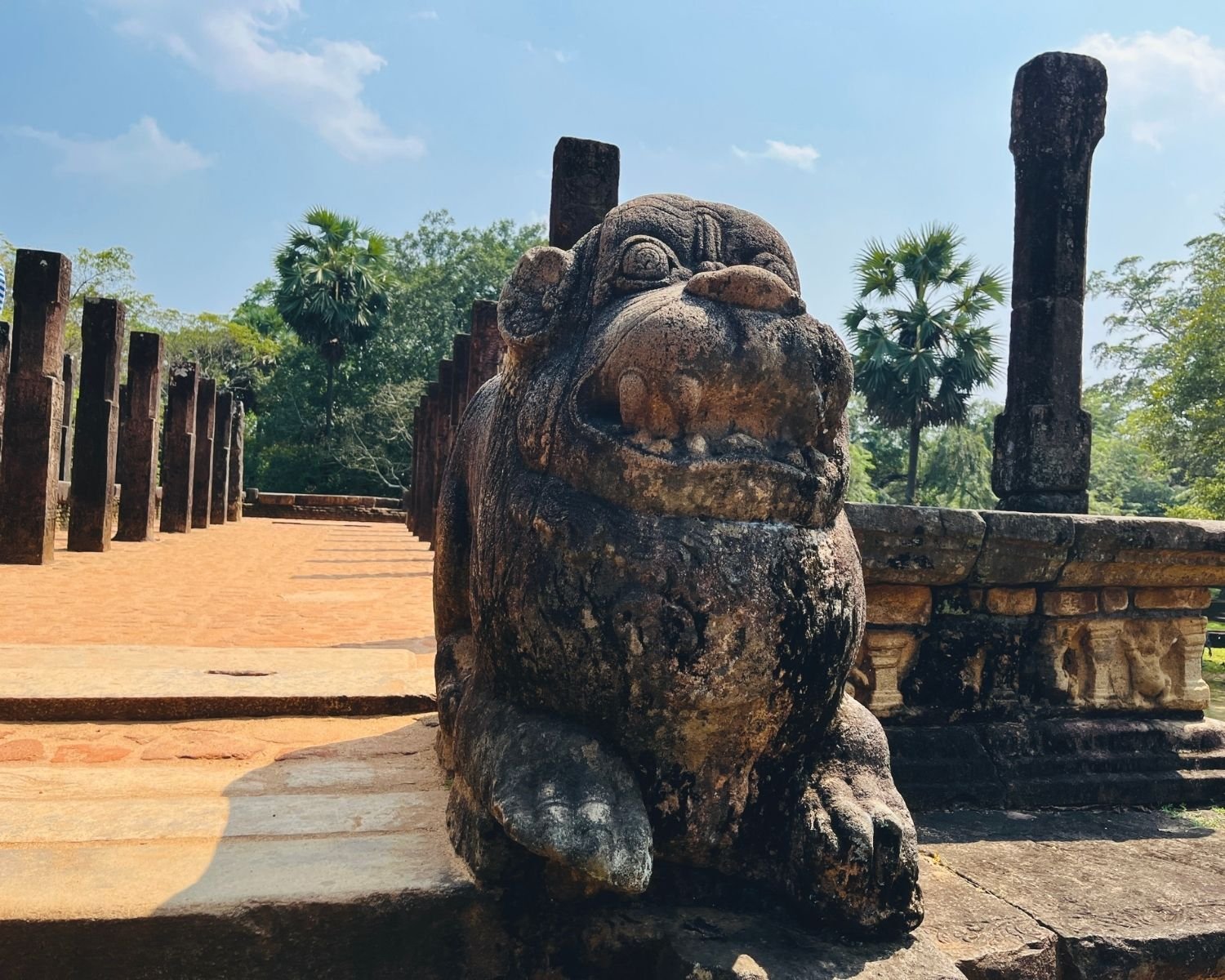 Close-up of carved lion guardian at Council Chamber with pillar rows behind