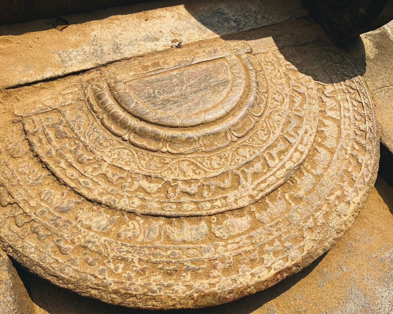 Moonstone at entrance steps of Council Chamber with concentric carved bands and floral motifs