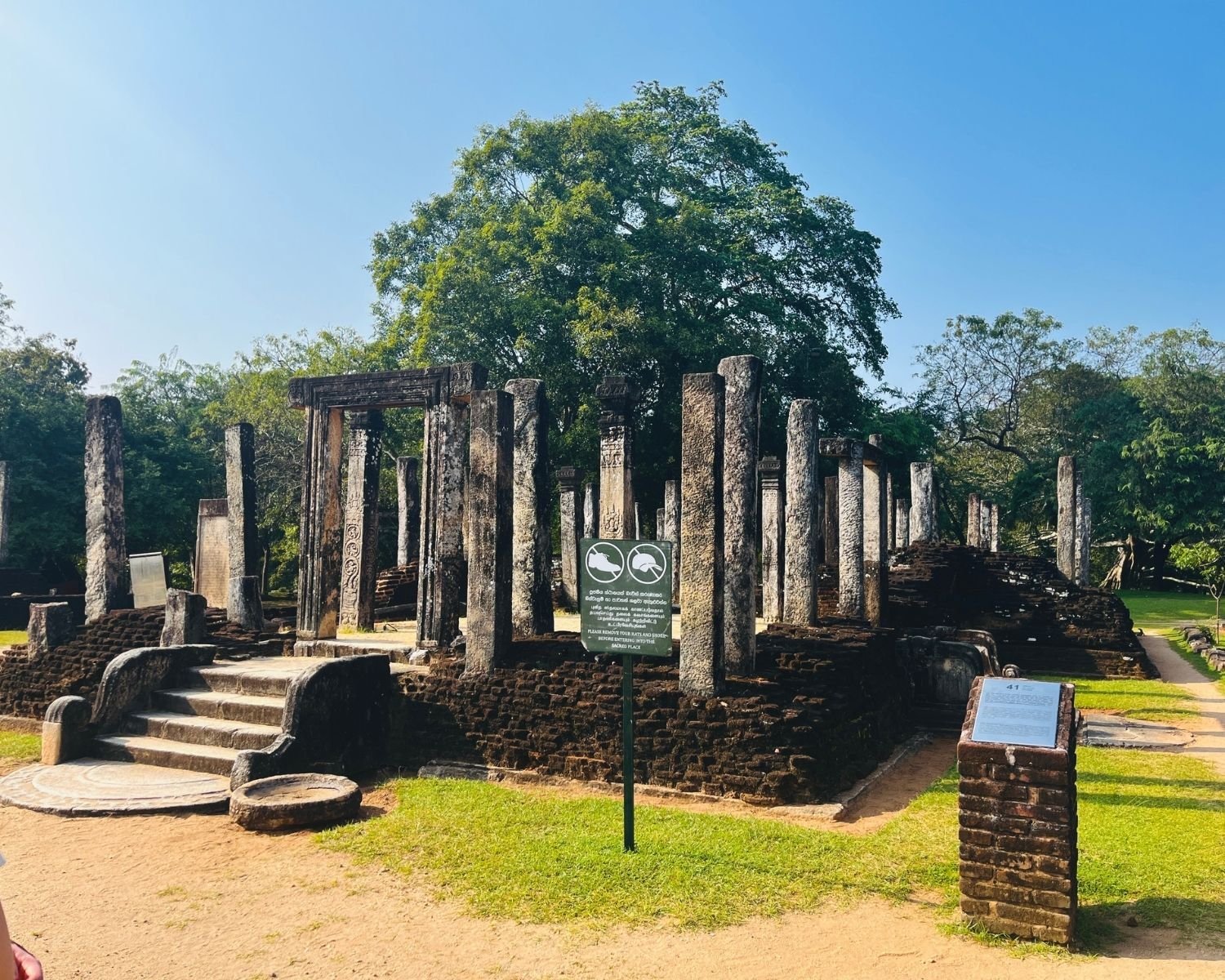 Full view of Atadage ruins with moonstone, steps, doorway, stone pillars, and brick platform