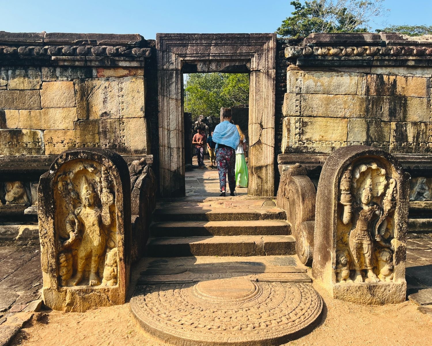 Front entrance of Hatadage with carved moonstone, twin guard stones, and inscribed stone walls