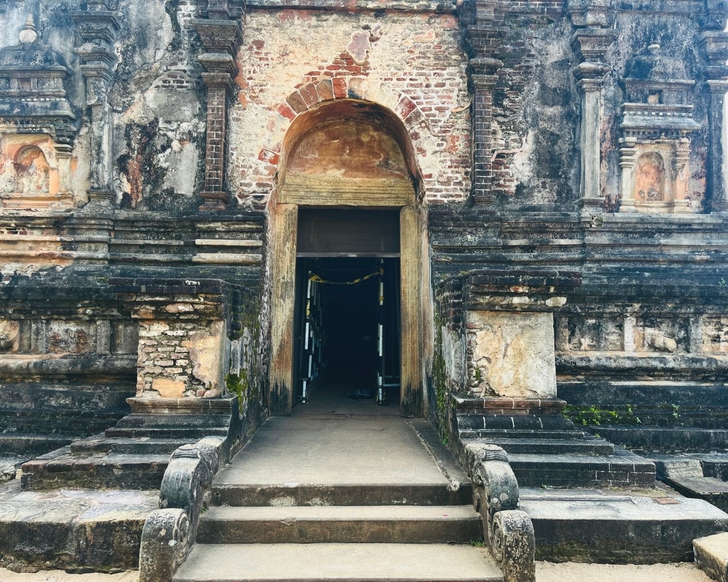 Stone and brick entrance facade of Thuparama Image House with steps, balustrades, and arched doorway
