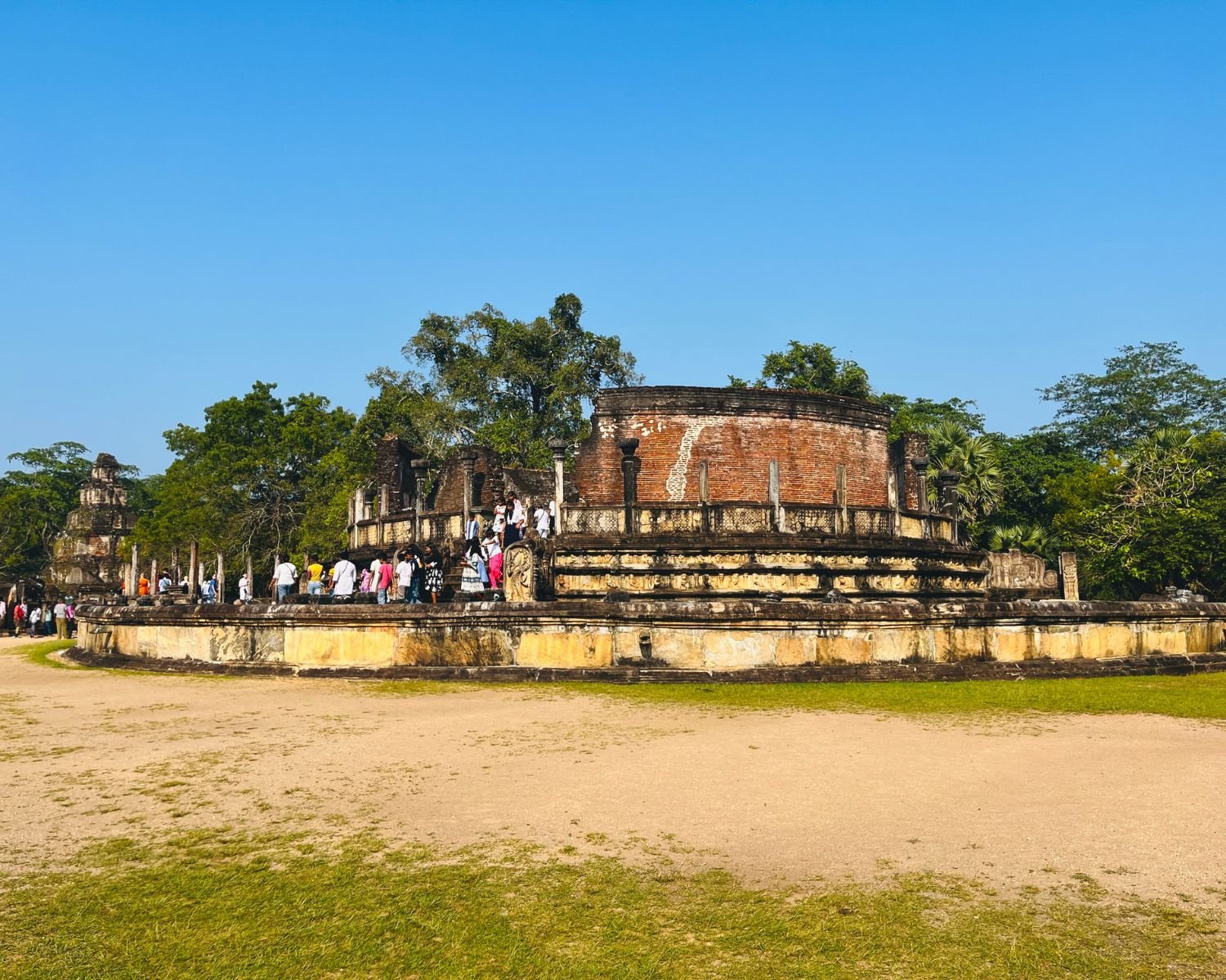 Vatadage circular relic house with brick drum, stone pillars, and Satmahal Prasada visible behind