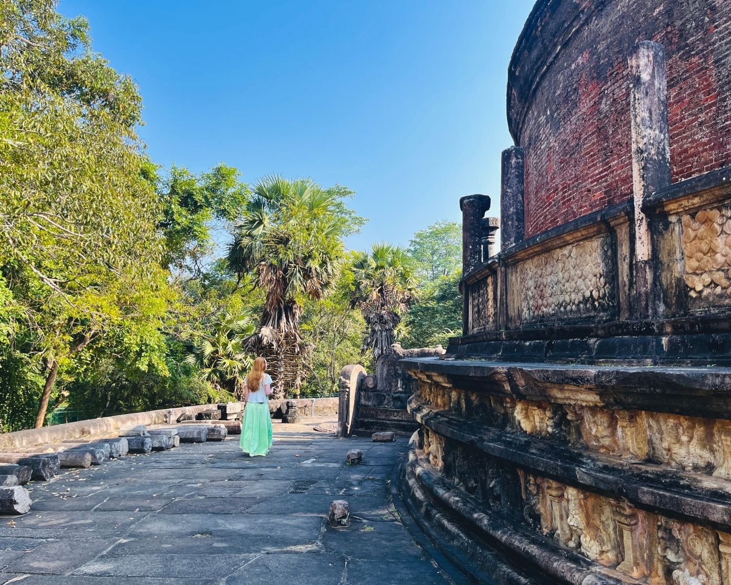 Outer stone platform of Vatadage with curved brick wall, lotus petal moldings, and staircase