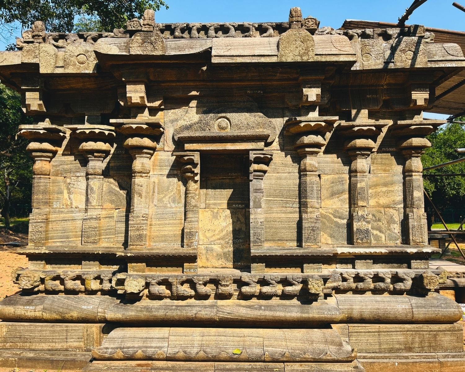 Close view of back wall of Shiva Devalaya No.1 with ornate pillars, false doorway, and sculpted cornice