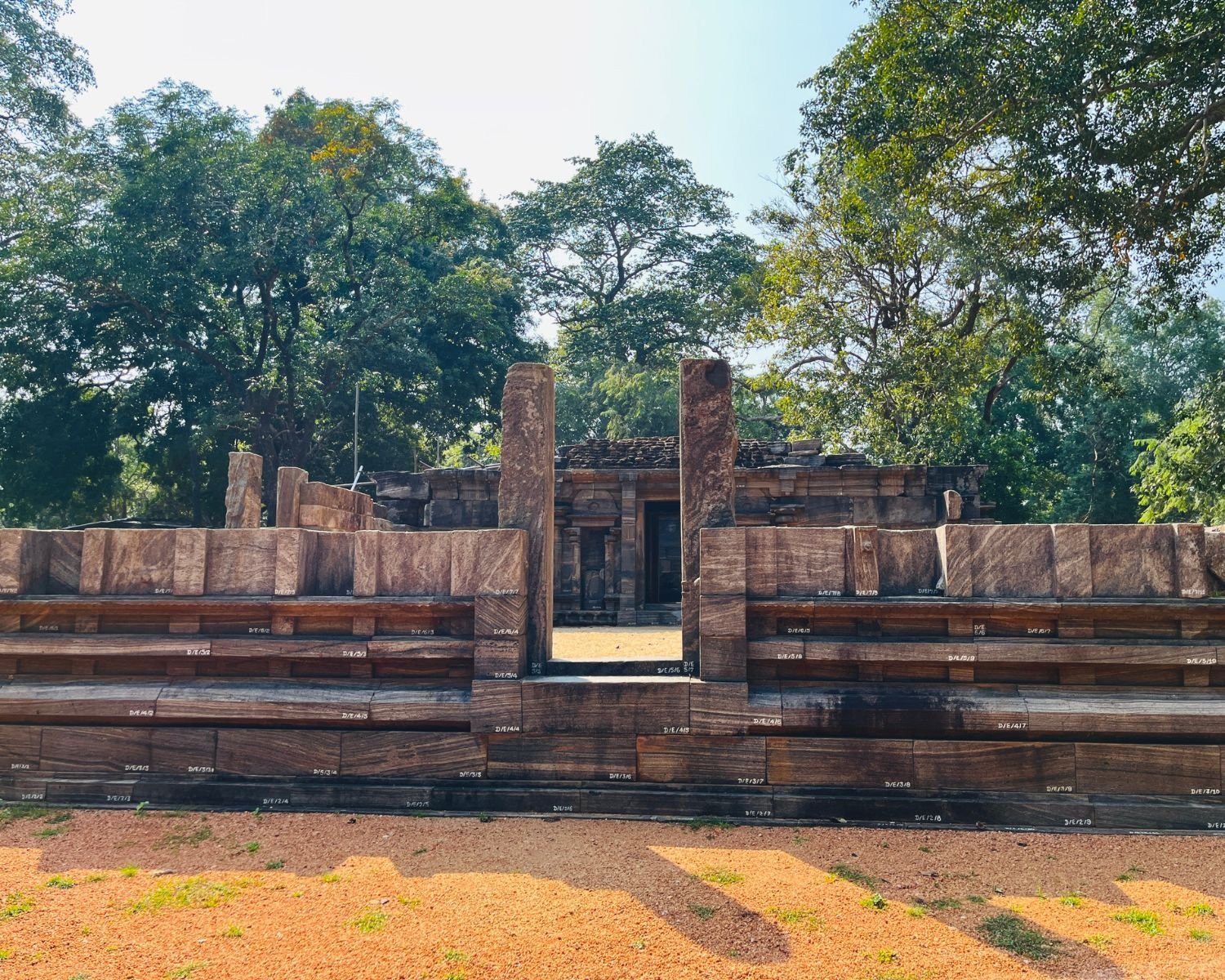 Close view of front entrance to Shiva Devalaya No.1 with numbered stone blocks, tiered walls, and sanctum doorway