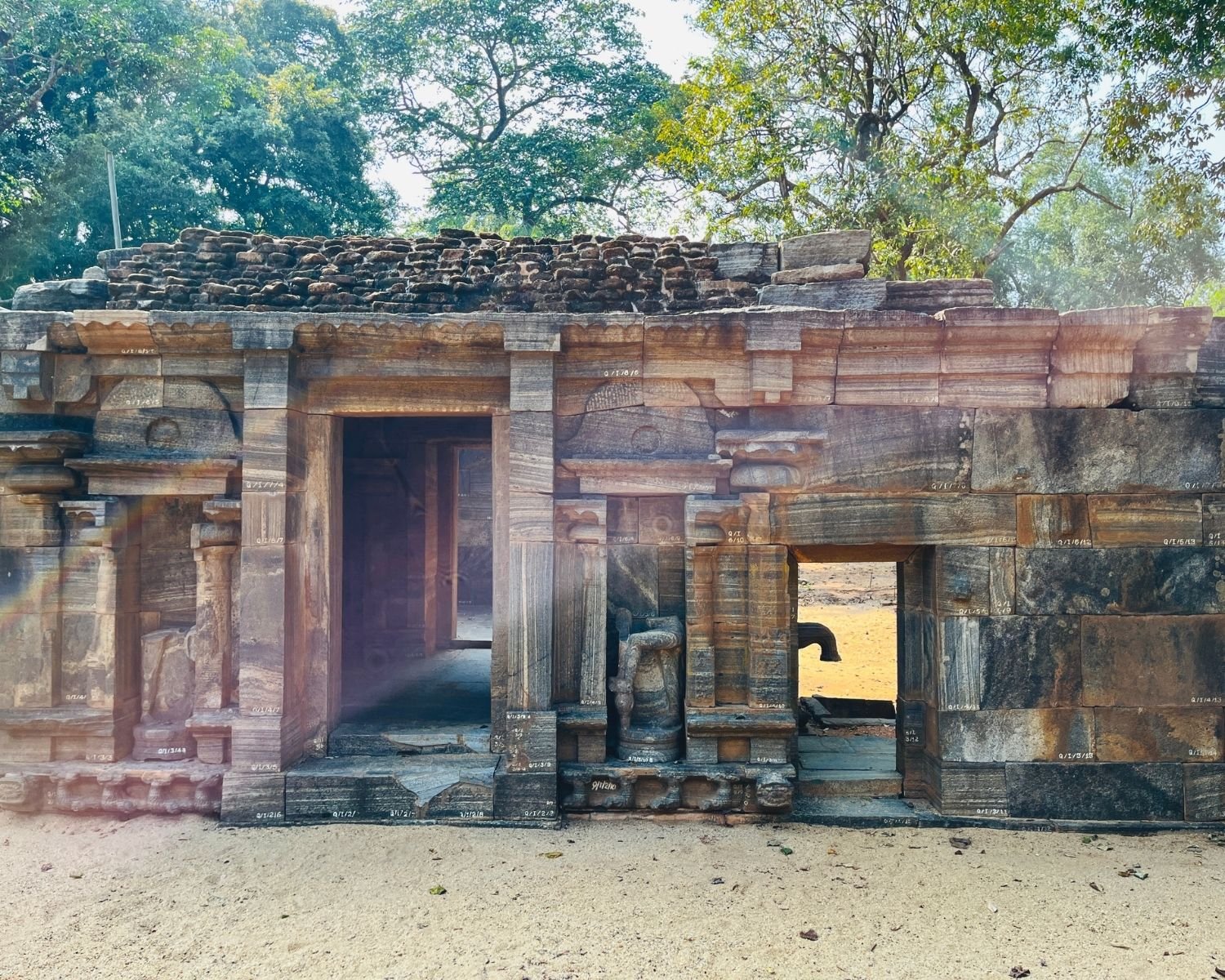Straight front view of inner shrine at Shiva Devalaya No.1 showing main doorway, side niches, and numbered stone blocks