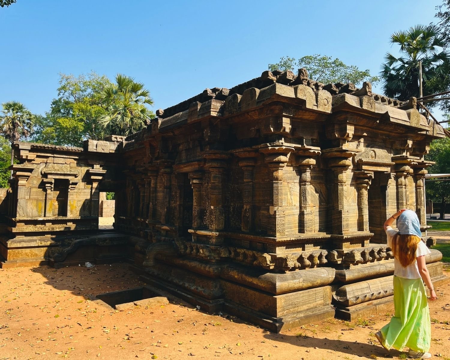 Side and back view of Shiva Devalaya No.1 showing tiered stone walls and detailed carvings