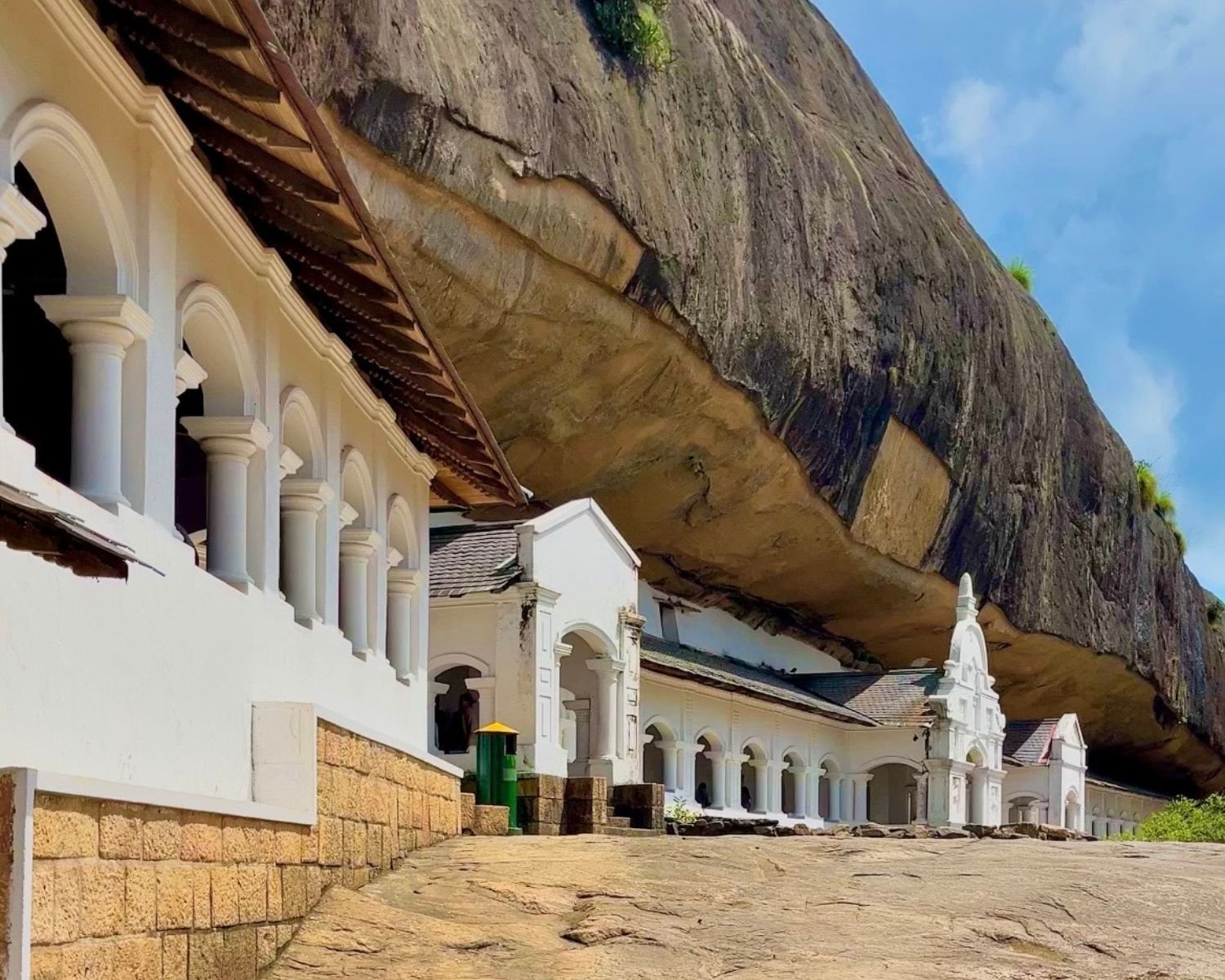 Long curved shrine façade beneath the rock shelter