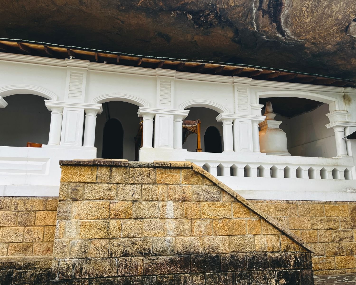 Shrine façade and stone staircase with a glimpse of the stupa