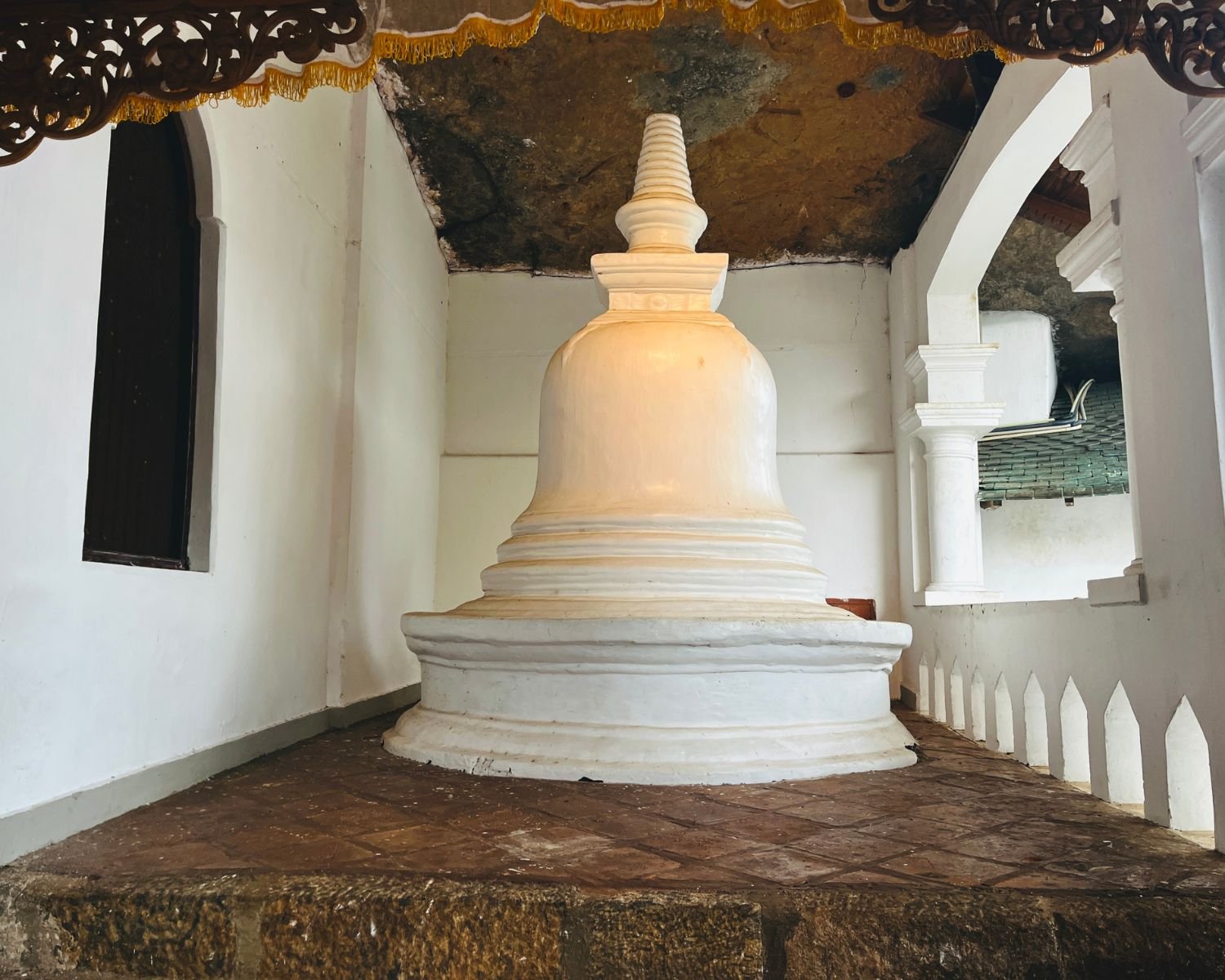 White stupa beneath the natural cave rock