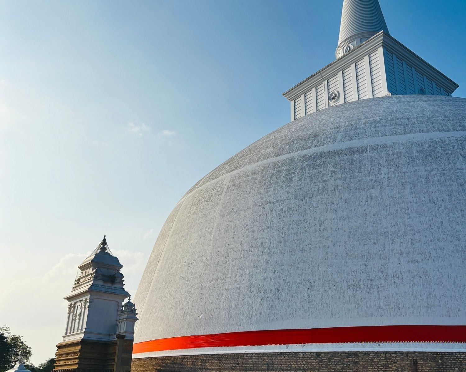 Ruwanwelisaya stupa dome and harmika with North Vahalkada from northwest angle in late light