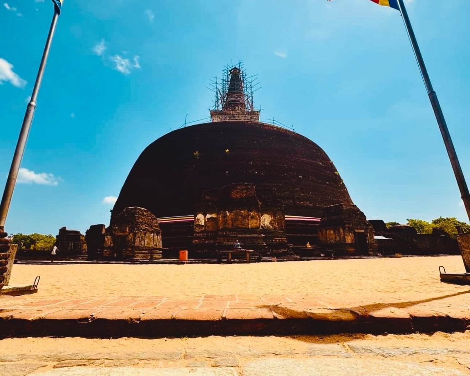 Rankoth Vehera brick stupa with vahalkada frontispieces and scaffolding on spire seen from sand terrace