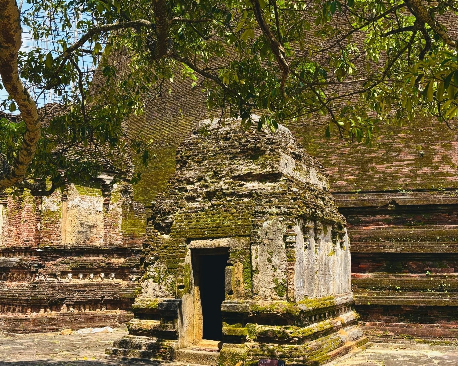 Moss-covered vahalkada frontispiece with doorway at base of Rankoth Vehera stupa