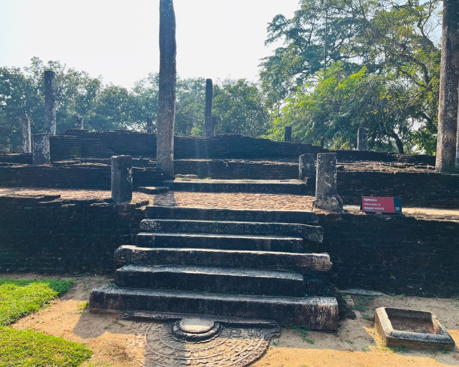 Stone steps and moonstone at entrance to Recumbent Buddha Image House 31 in Sacred Quadrangle