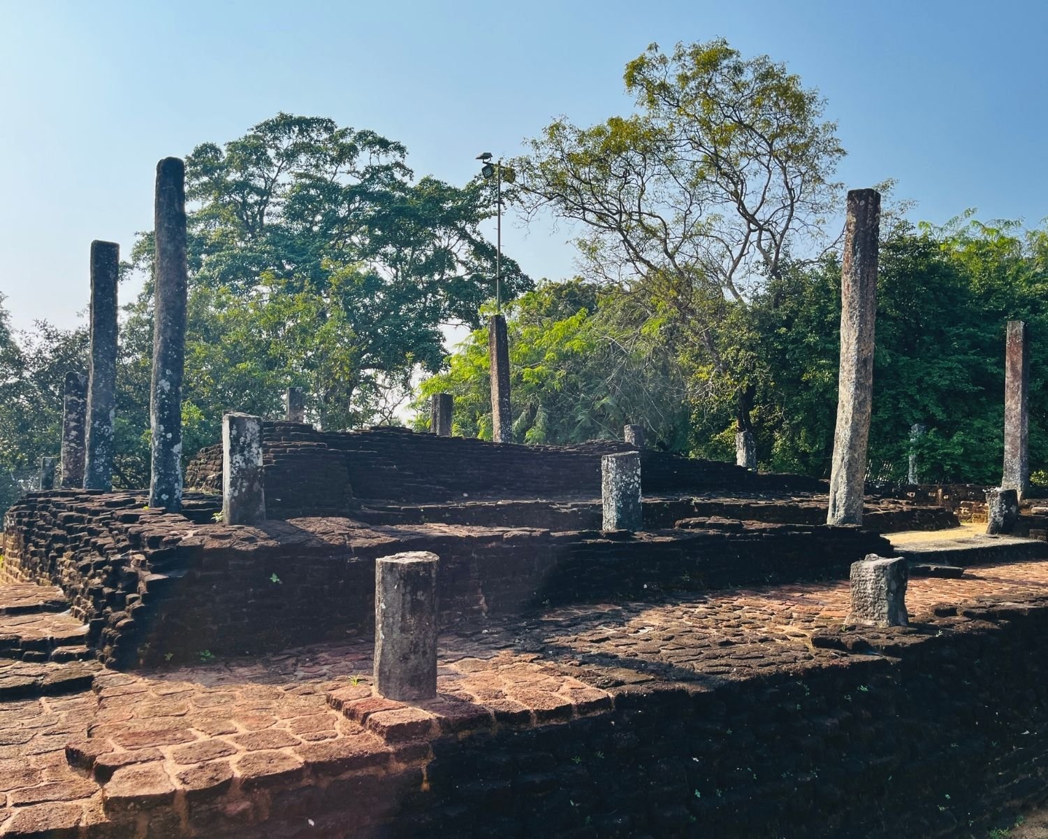 Brick platform and stone pillars of Recumbent Buddha Image House in Sacred Quadrangle