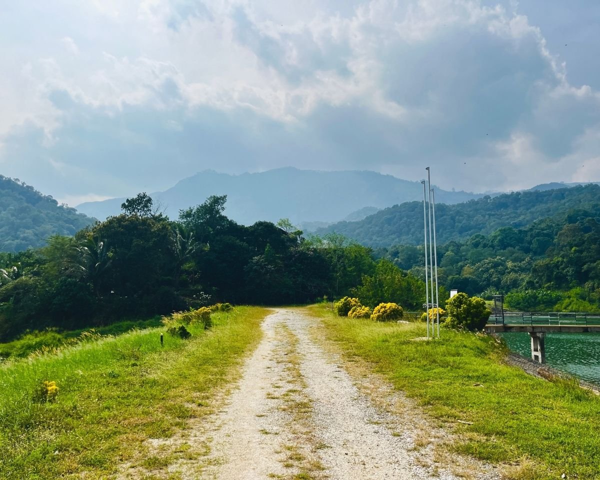 Reservoir bund overlooking distant mountain ridges