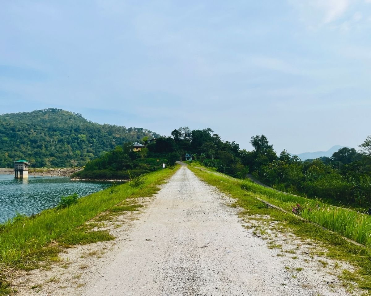 Gravel road running along the reservoir embankment