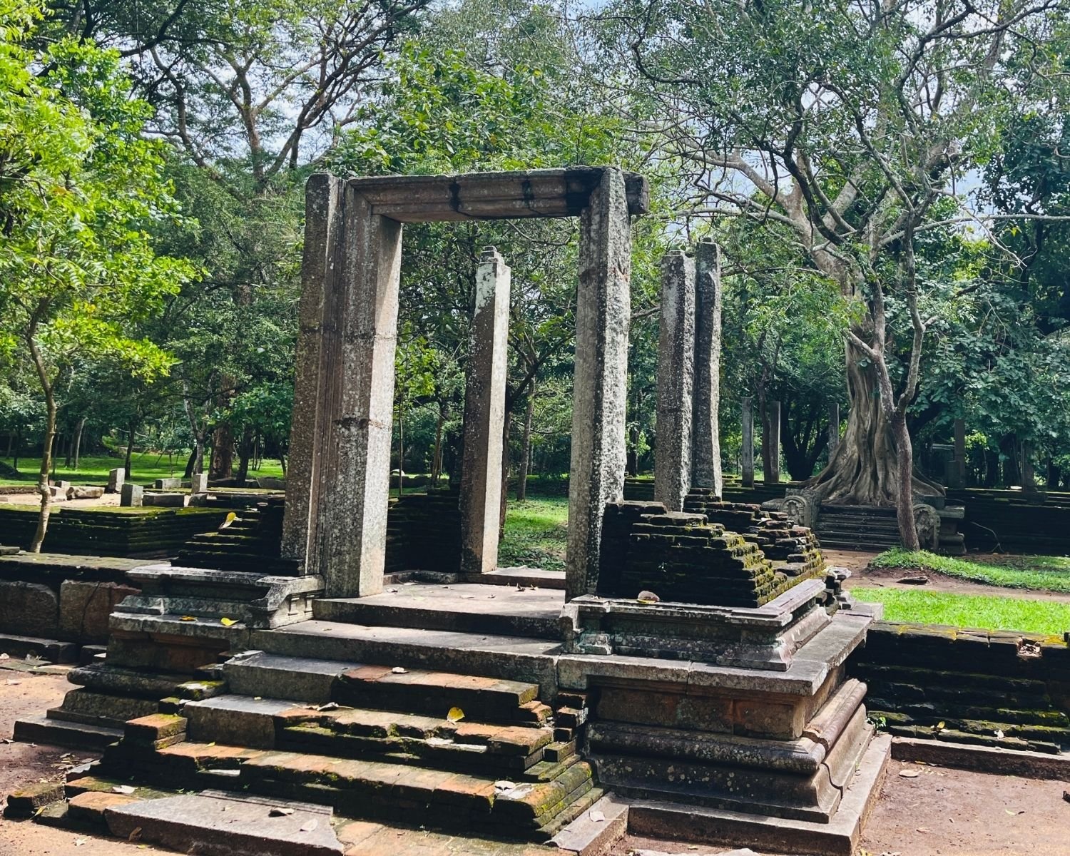 Front view of mossy west stone doorway with steps leading to the platform of Abhayagiri Banyan Tree Shrine in Anuradhapura