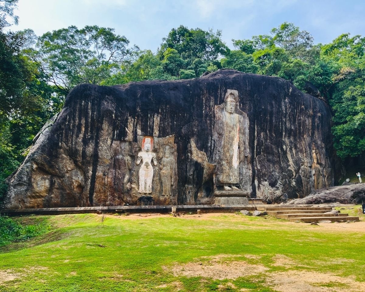 Full frontal view of the Buduruwagala rock carvings and central Buddha statue