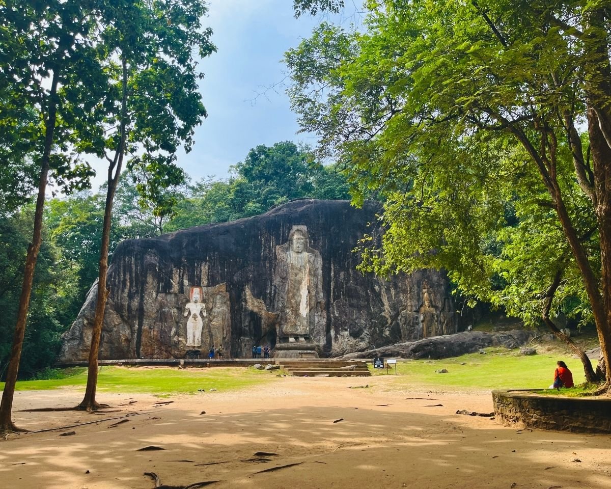 Seven ancient rock-carved statues at Buduruwagala dominated by a towering central Buddha