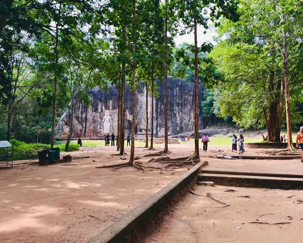 Visitors approaching the Buduruwagala carvings through the forest