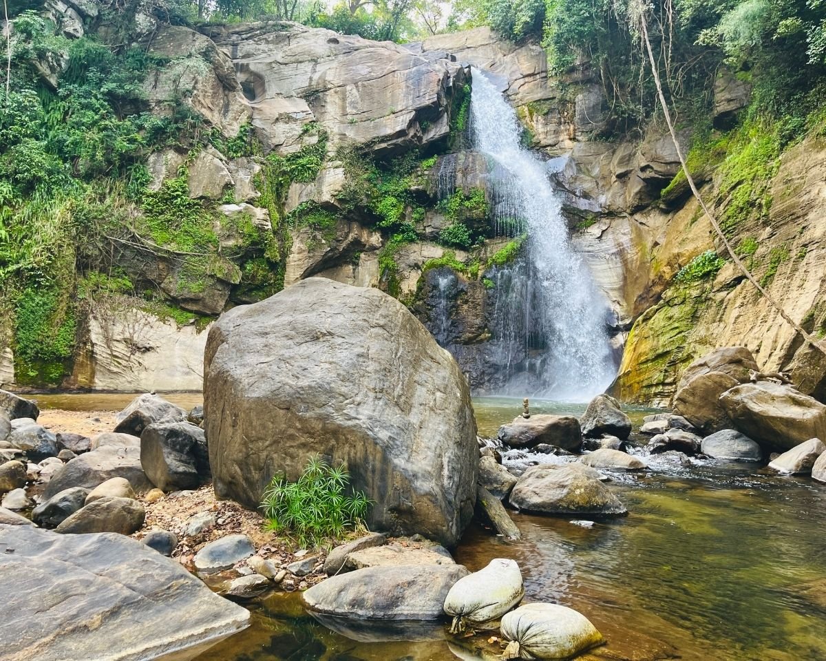 Ellewala Waterfall surrounded by boulders and a sandy stream bed