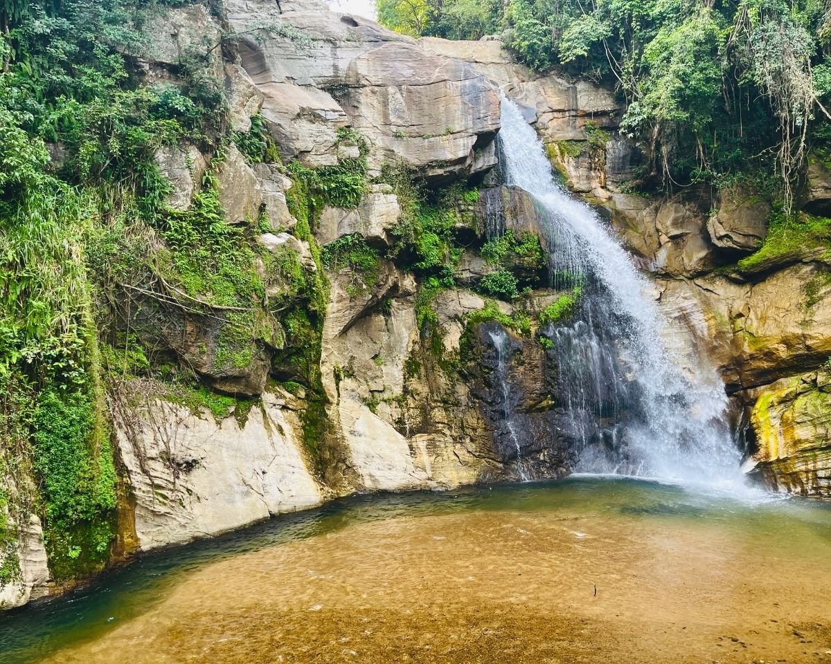 Water flowing down the rock face into a clear pool