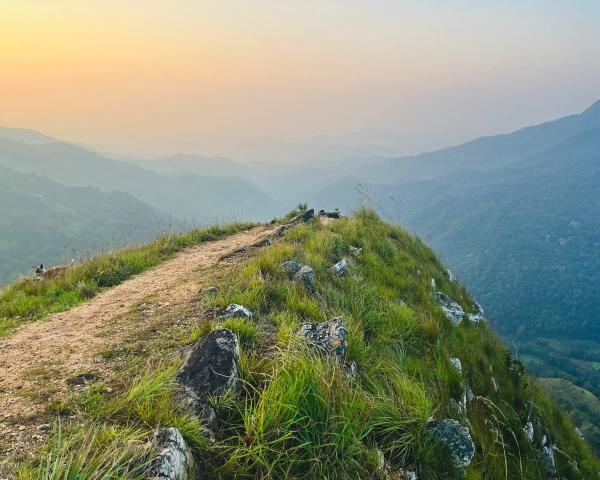 Rocky ridge overlooking mountain valleys at sunrise