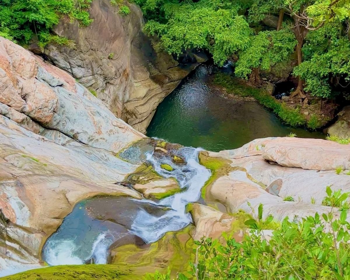 Water cascading over rocky ledges into a natural basin