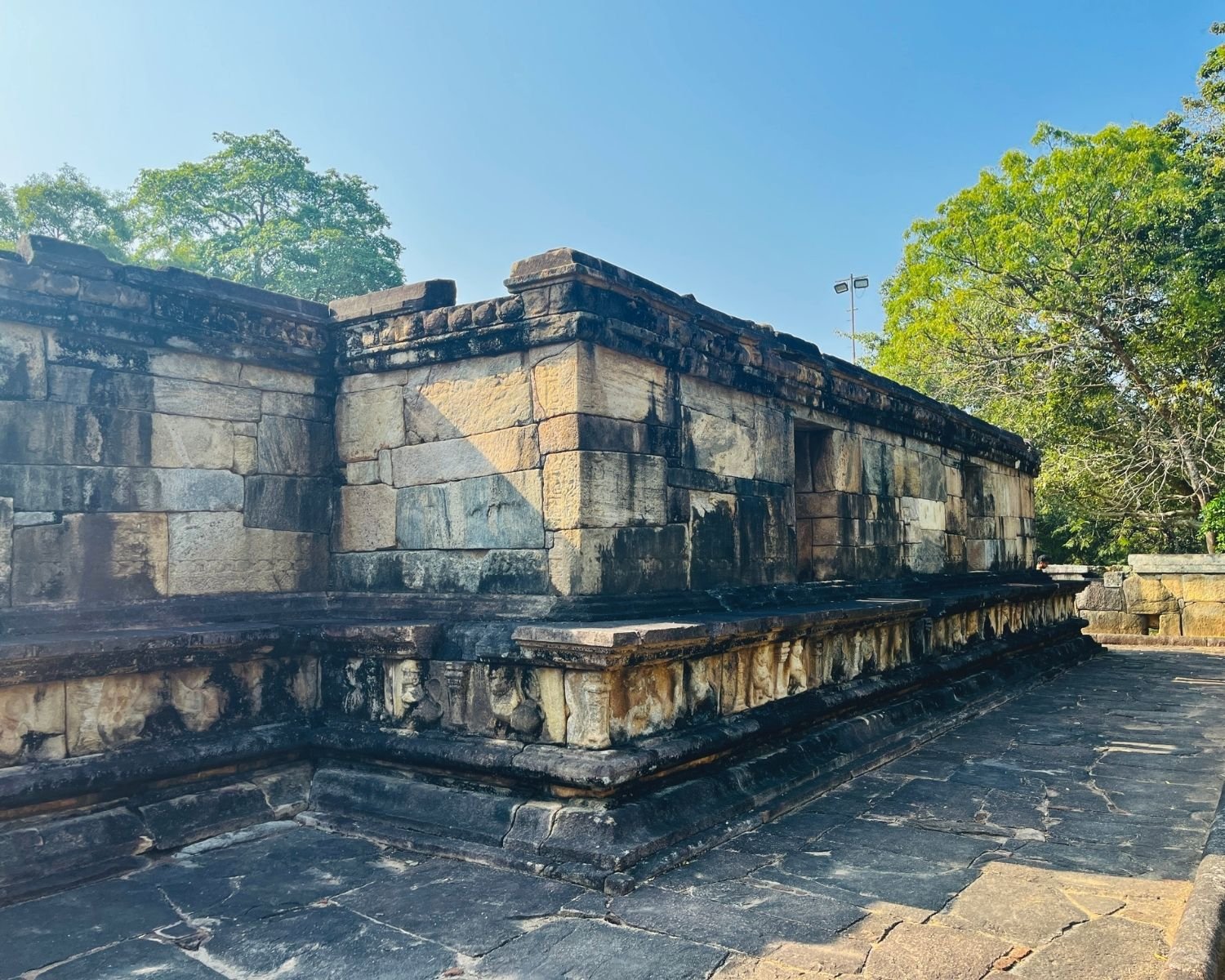 Exterior stone walls of Hatadage with carved dwarf frieze and corner masonry