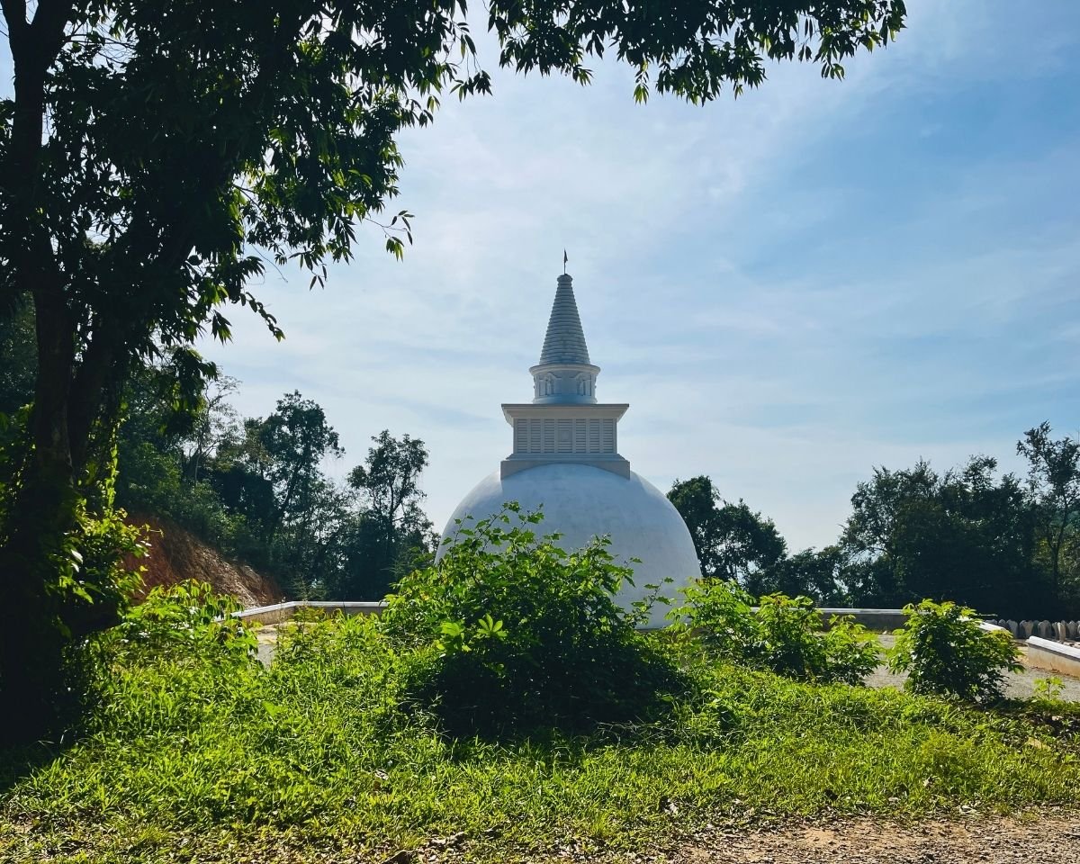 White stupa standing at the temple entrance