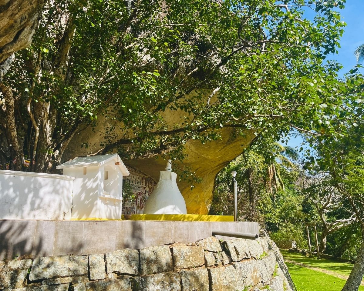 White stupa and shrine beneath a sacred Bo tree