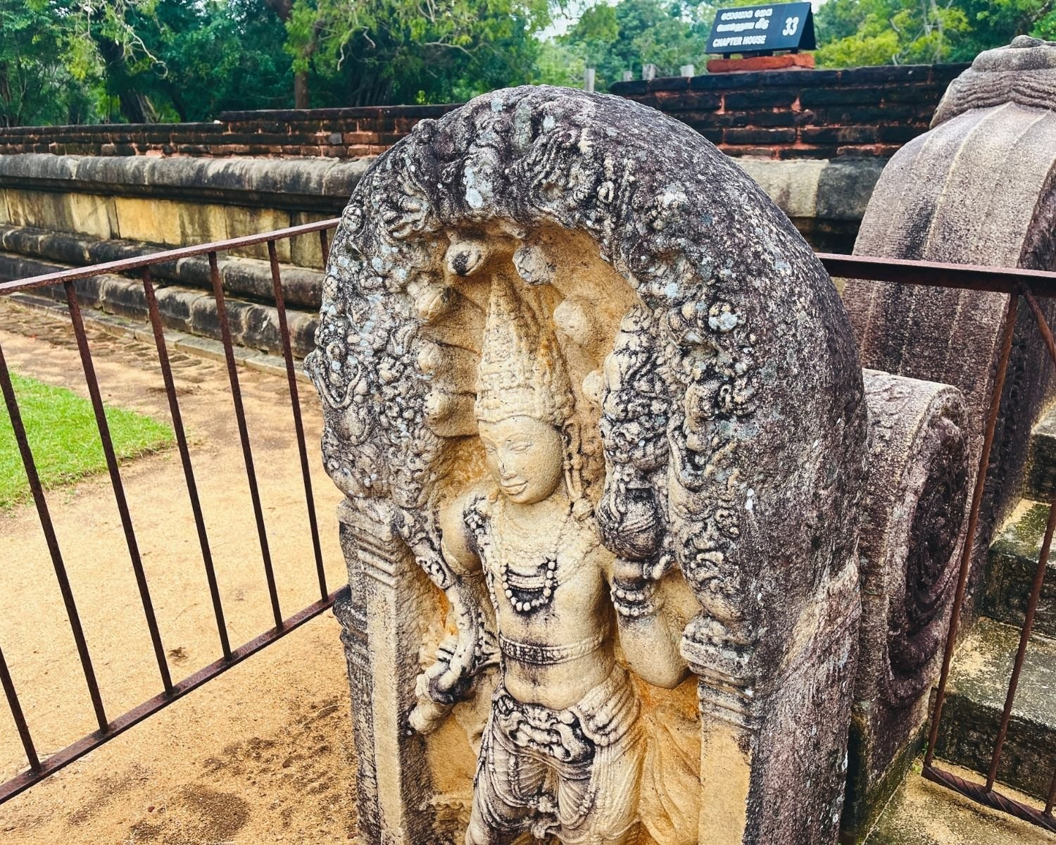 Rathna Prasadaya guardstone muragala at Abhayagiri, the most beautiful and detailed guardstone found in Sri Lanka, 7th–9th century Nagaraja cobra king carving under seven-hooded serpent canopy with makara arch, holding punkalasa pot of abundance, beside Chapter House steps