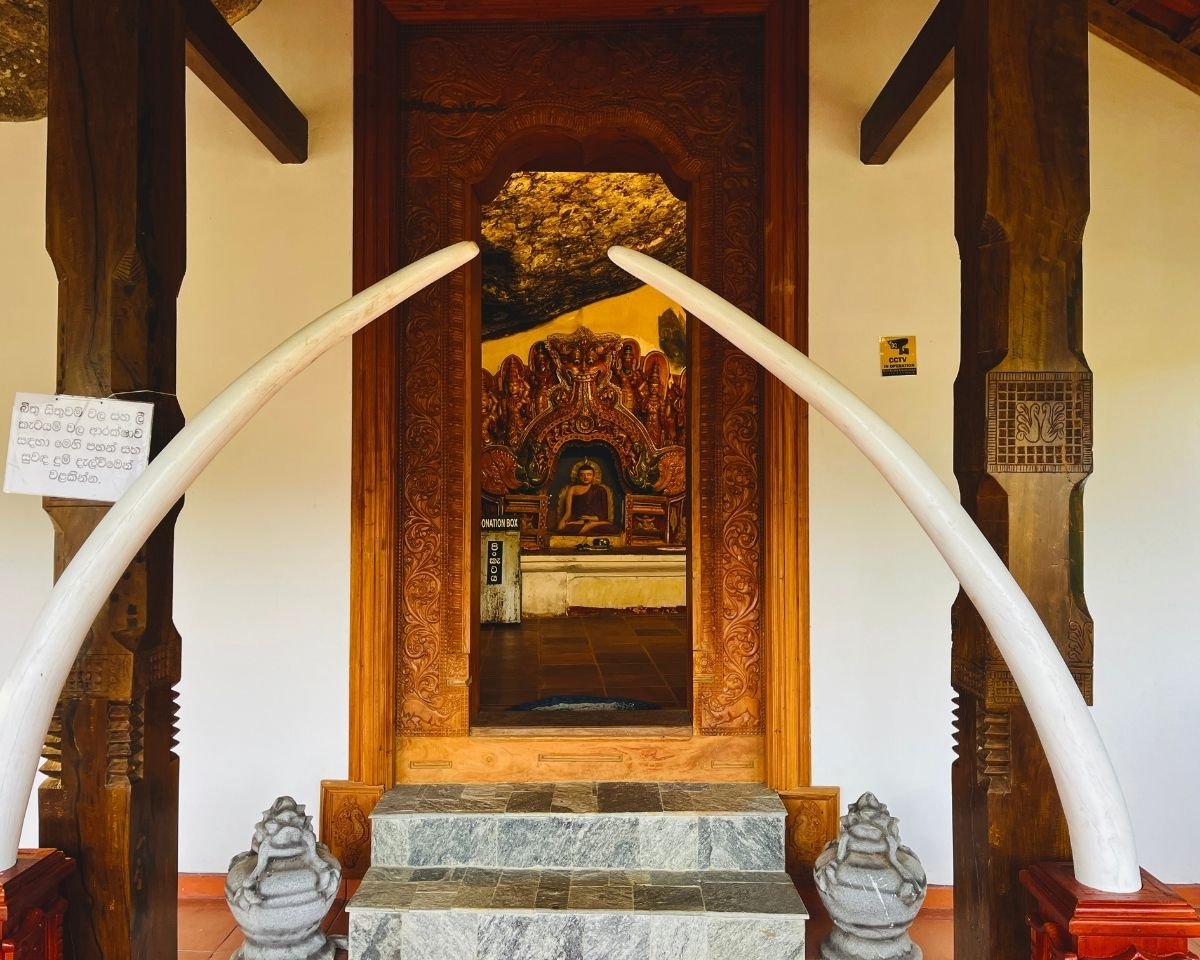 Ornate shrine entrance framed by elephant tusks