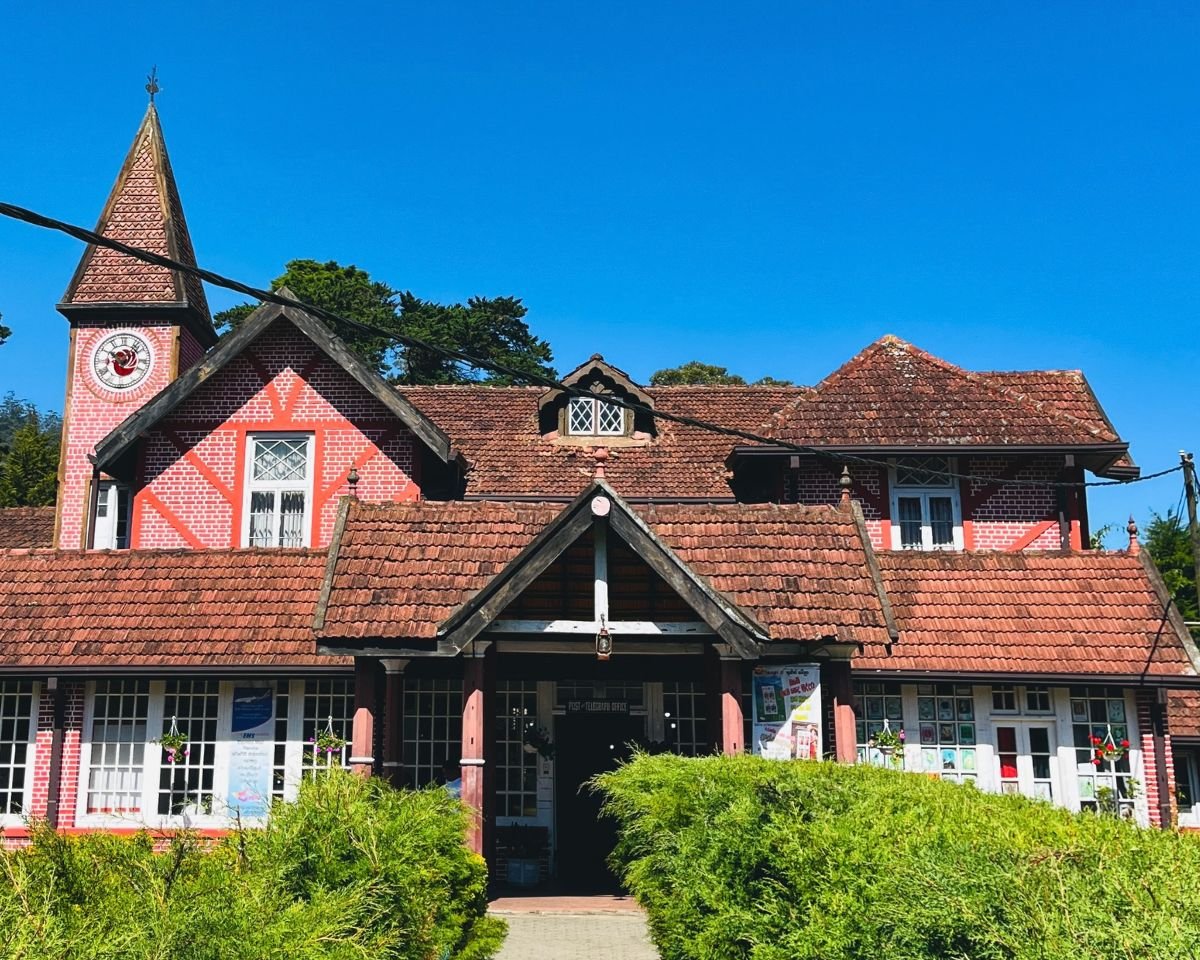 Nuwara Eliya Post Office red brick Tudor building with clock tower and timber framing under blue sky Sri Lanka