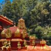Seetha Amman Kovil - Gopuram and Vimana at Nuwara Eliya Red and gold gopuram temple tower with golden deity statues at Seetha Amman Kovil, Nuwara Eliya, Sri Lanka surrounded by eucalyptus forest