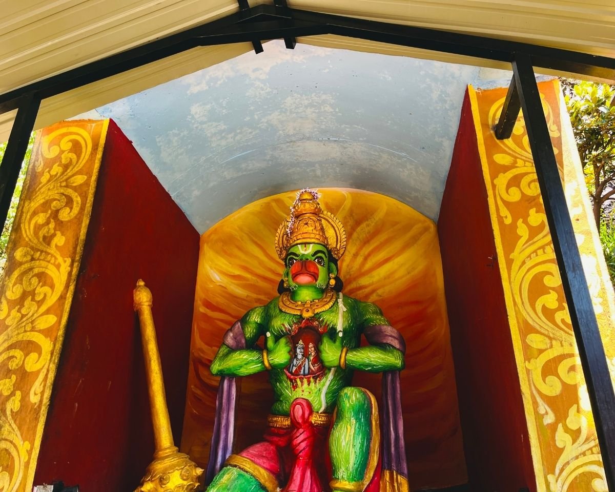 Green Hanuman statue with chest open showing Rama and Sita inside at Seetha Amman Kovil Hindu temple in Nuwara Eliya, Sri Lanka