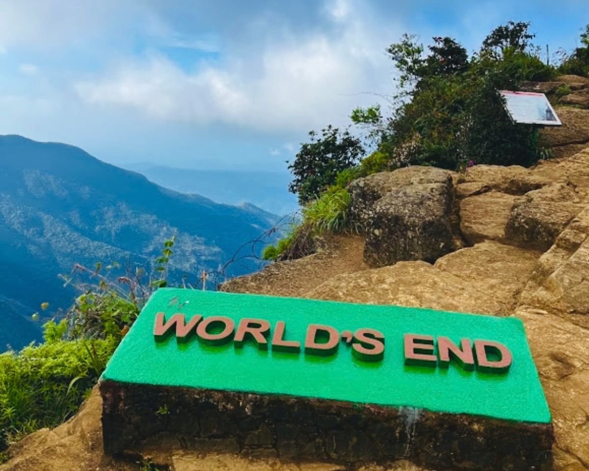 Green World's End sign at cliff edge with 870m drop and mountain view at Horton Plains National Park, Sri Lanka